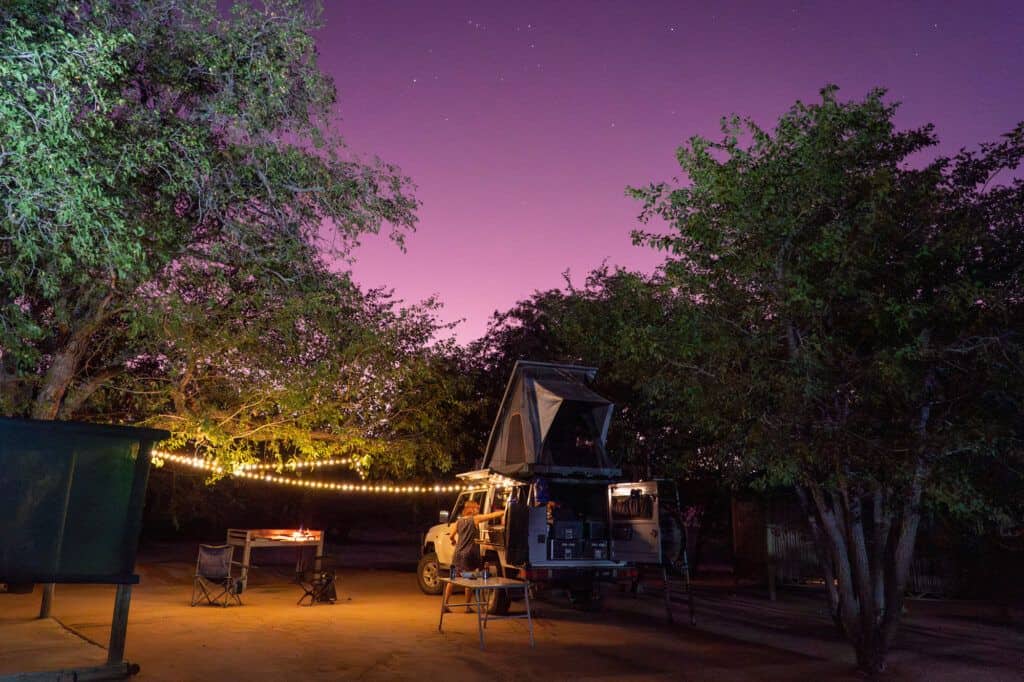campsite at dusk, the sky pink after sunset